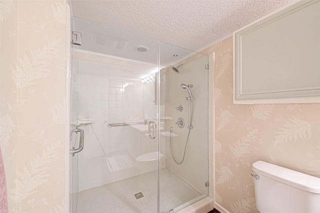 2277 S Kirkwood Rd Unit 906, Houston, TX 77077 - full bathroom with a textured ceiling, wallpapered walls, and a shower stall