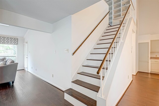 2277 S Kirkwood Rd Unit 906, Houston, TX 77077 - stairs with wood finished floors and baseboards