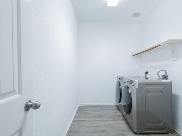 14110 Long Meadow Dr, Houston, TX 77047 - washroom with washer and dryer and light wood-style flooring