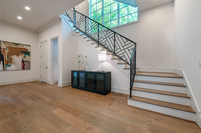 3028 Locke Ln, Houston, TX 77019 - stairs featuring wood-type flooring, ornamental molding, and recessed lighting