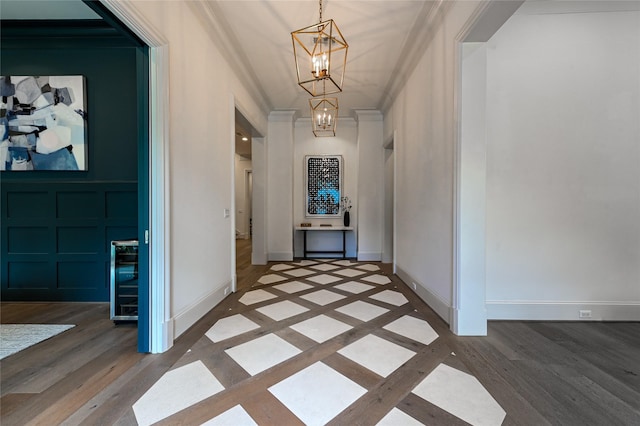 3028 Locke Ln, Houston, TX 77019 - hall featuring a chandelier, crown molding, beverage cooler, and wood finished floors