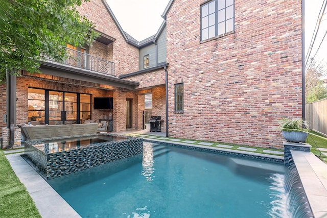 3028 Locke Ln, Houston, TX 77019 - view of pool featuring exterior fireplace, a patio, a pool with connected hot tub, and a grill