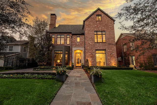 3028 Locke Ln, Houston, TX 77019 - view of front of house with a front lawn, a chimney, brick siding, and a shingled roof