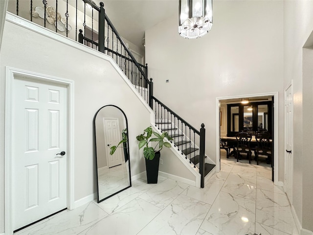 7902 Granite Ridge Ln, Houston, TX 77095 - entrance foyer featuring marble finish floors, a high ceiling, stairway, and a chandelier