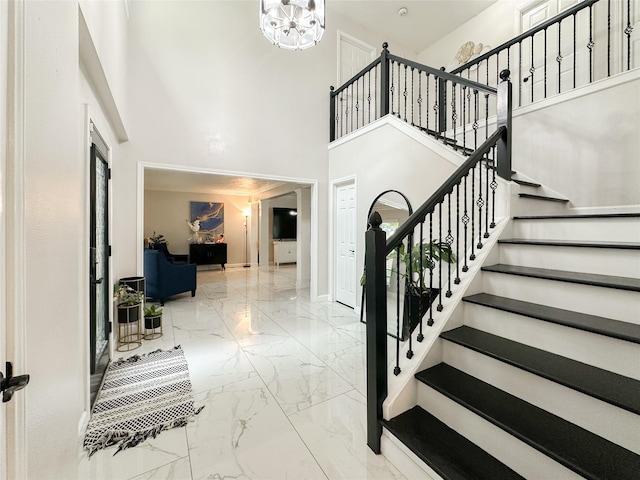 7902 Granite Ridge Ln, Houston, TX 77095 - stairway with marble finish floors, a towering ceiling, and a chandelier