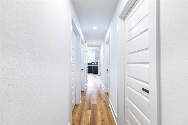 9804-9808 Pelsey St, Houston, TX 77029 - corridor featuring a textured wall, wood finished floors, recessed lighting, and built in features