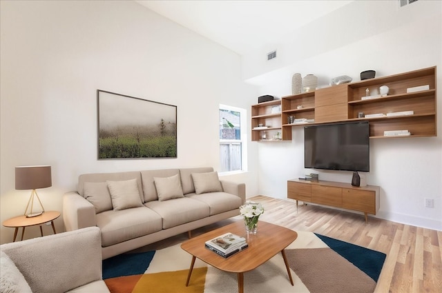 9804-9808 Pelsey St, Houston, TX 77029 - living area with light wood-style floors and a towering ceiling