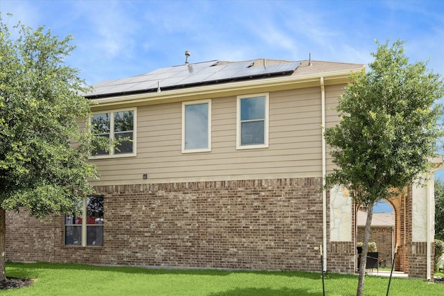 29513 Salem Fields Dr, Spring, TX 77386 - view of side of home with solar panels, brick siding, and a yard