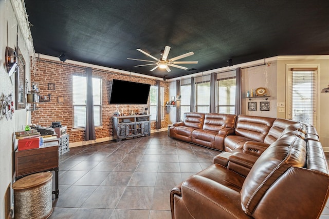 29513 Salem Fields Dr, Spring, TX 77386 - tiled living room featuring a ceiling fan, brick wall, and crown molding