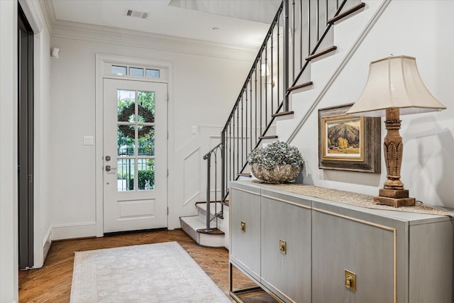 311 Royale Heights Ln, Houston, TX 77024 - foyer entrance with stairs, crown molding, and light wood-style flooring