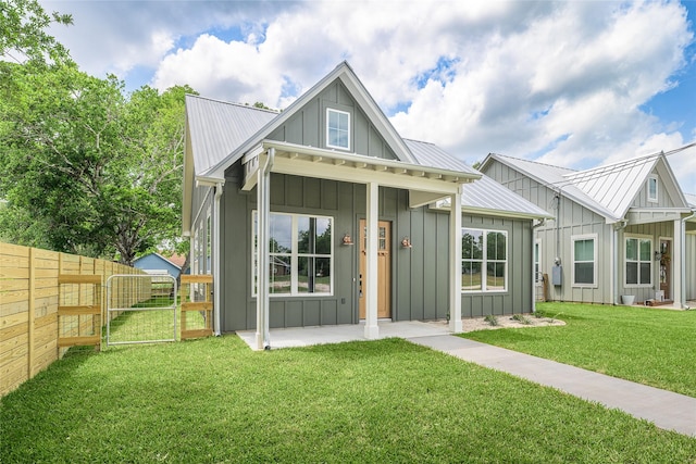 741 Pecan St, New Ulm, TX 78950 - modern inspired farmhouse with board and batten siding, a gate, and a metal roof