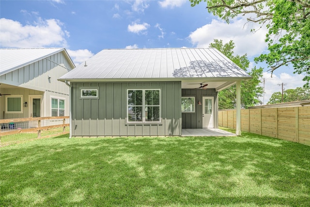 741 Pecan St, New Ulm, TX 78950 - back of property with board and batten siding, a patio area, a fenced backyard, a metal roof, and ceiling fan
