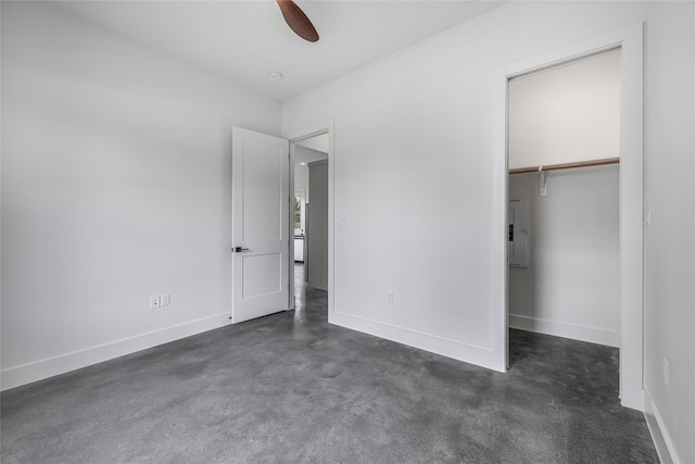 741 Pecan St, New Ulm, TX 78950 - unfurnished bedroom featuring a closet, concrete floors, ceiling fan, and a spacious closet