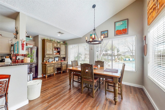 3114 Whetrock Ln, Sugar Land, TX 77479 - dining room featuring a chandelier, lofted ceiling, a textured ceiling, and dark wood-style floors