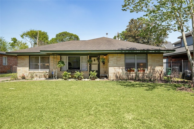 6625 Fairfield St, Houston, TX 77023 - ranch-style home with brick siding, a front yard, and a shingled roof