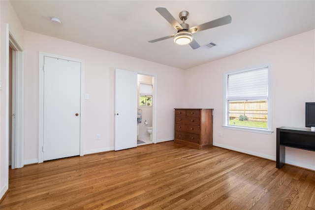 6625 Fairfield St, Houston, TX 77023 - unfurnished bedroom featuring light wood-style floors, connected bathroom, and a ceiling fan