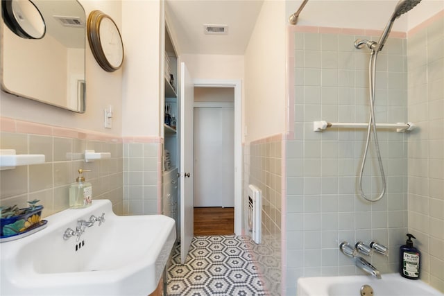 6625 Fairfield St, Houston, TX 77023 - full bath with tile walls,  shower combination, wainscoting, and heating unit