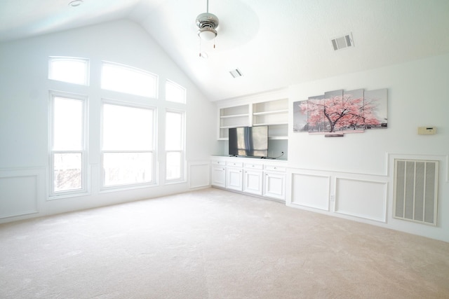 23410 Wellington Court Blvd, Spring, TX 77389 - unfurnished living room with light carpet, lofted ceiling, a decorative wall, and a ceiling fan