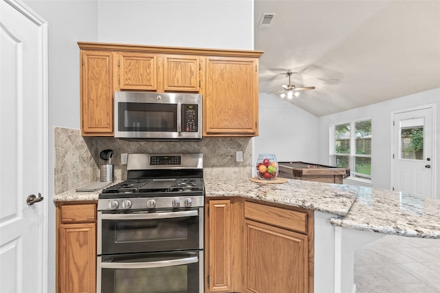 16439 Willingham Way, Houston, TX 77095 - kitchen with appliances with stainless steel finishes, lofted ceiling, a ceiling fan, backsplash, and a peninsula