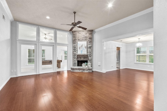 16439 Willingham Way, Houston, TX 77095 - unfurnished living room featuring a ceiling fan, ornamental molding, a fireplace, wood finished floors, and a chandelier
