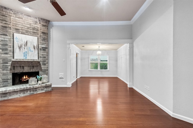 16439 Willingham Way, Houston, TX 77095 - unfurnished living room featuring ornamental molding, a ceiling fan, wood finished floors, a fireplace, and a chandelier