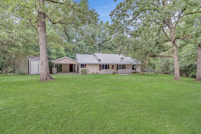123 Sea Gull Dr, Livingston, TX 77351 - rear view of property with a porch, a yard, a shed, and a metal roof