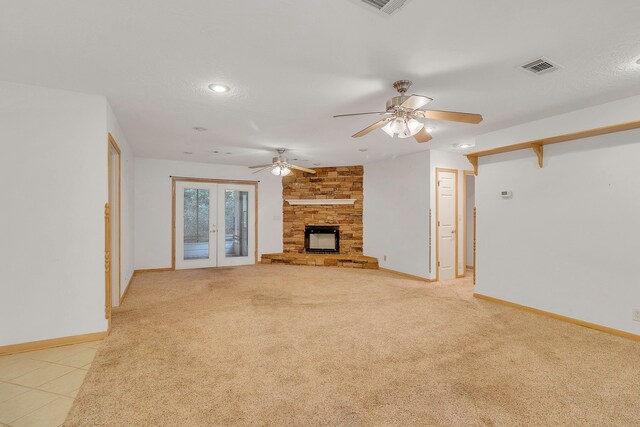 123 Sea Gull Dr, Livingston, TX 77351 - unfurnished living room with recessed lighting, a ceiling fan, a fireplace, light colored carpet, and french doors