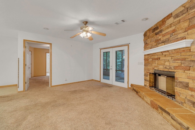 123 Sea Gull Dr, Livingston, TX 77351 - unfurnished living room featuring french doors, carpet floors, a ceiling fan, and a fireplace