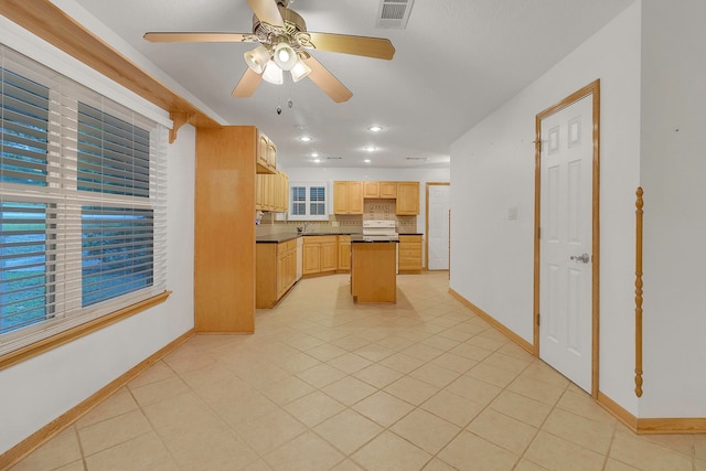 123 Sea Gull Dr, Livingston, TX 77351 - kitchen with white range oven, light brown cabinets, decorative backsplash, ceiling fan, and a kitchen island