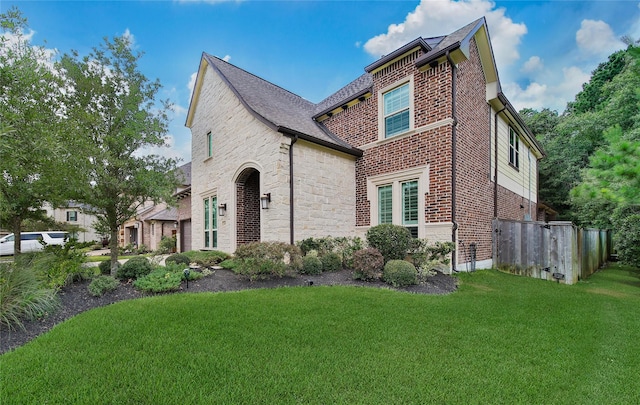 145 Bronze Bow Dr, Montgomery, TX 77316 - view of front of home with brick siding, a front lawn, and stone siding