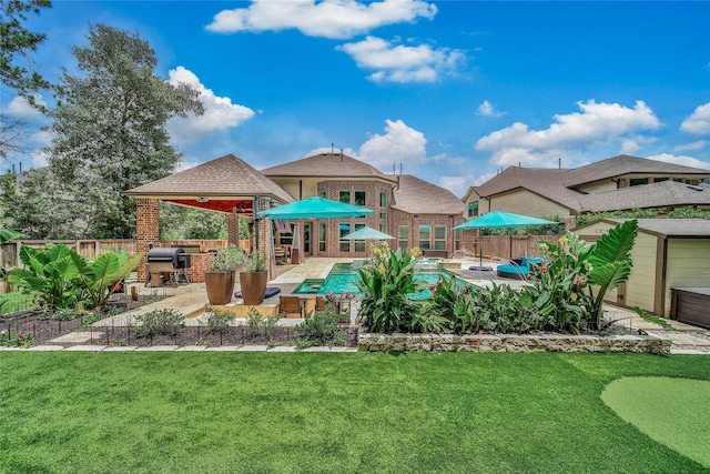 145 Bronze Bow Dr, Montgomery, TX 77316 - exterior space with a patio, brick siding, a fenced backyard, and exterior kitchen