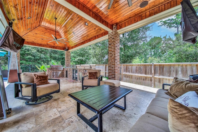 145 Bronze Bow Dr, Montgomery, TX 77316 - fenced backyard with exterior kitchen, a ceiling fan, outdoor lounge area, and a patio area