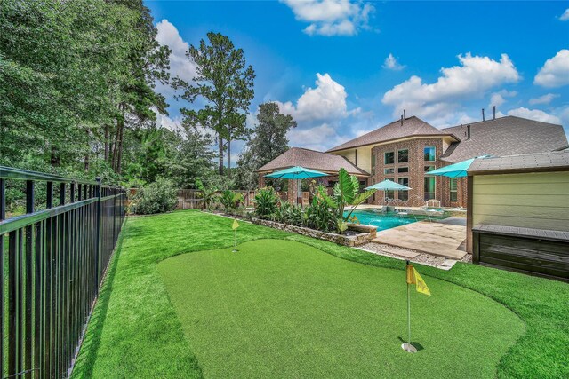 145 Bronze Bow Dr, Montgomery, TX 77316 - fenced backyard with a putting area, a pool with connected hot tub, and a patio