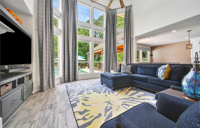 145 Bronze Bow Dr, Montgomery, TX 77316 - living area featuring healthy amount of natural light, a towering ceiling, light wood-style floors, and recessed lighting