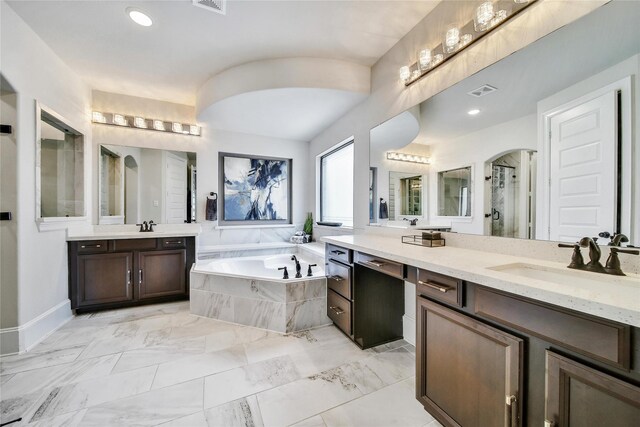 145 Bronze Bow Dr, Montgomery, TX 77316 - full bath with two vanities, a garden tub, a stall shower, marble finish floors, and recessed lighting
