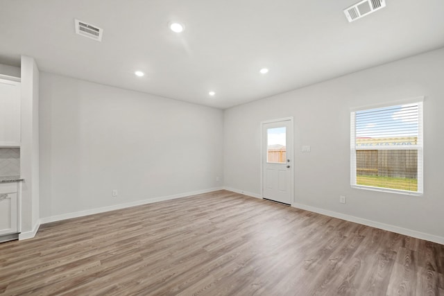 25017 Pomegranate Pl, Montgomery, TX 77316 - unfurnished living room featuring light wood finished floors and recessed lighting