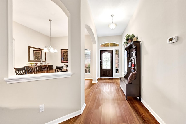 6318 Crystal Forest Trl, Katy, TX 77493 - entrance foyer with arched walkways, wood finished floors, and a chandelier