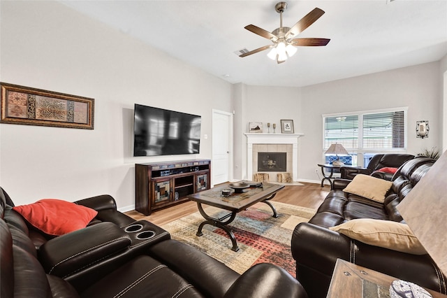 6318 Crystal Forest Trl, Katy, TX 77493 - living room with light wood-style floors, a ceiling fan, and a fireplace