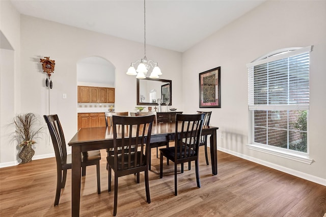 6318 Crystal Forest Trl, Katy, TX 77493 - dining space featuring light wood-style flooring, a chandelier, and arched walkways