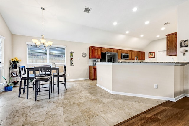 6318 Crystal Forest Trl, Katy, TX 77493 - kitchen featuring stainless steel microwave, fridge with ice dispenser, vaulted ceiling, a chandelier, and plenty of natural light