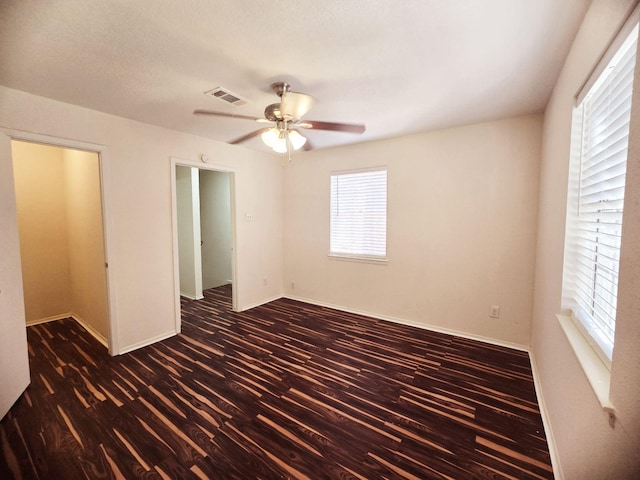 7837 Leonora St, Houston, TX 77061 - unfurnished bedroom featuring dark wood finished floors and ceiling fan