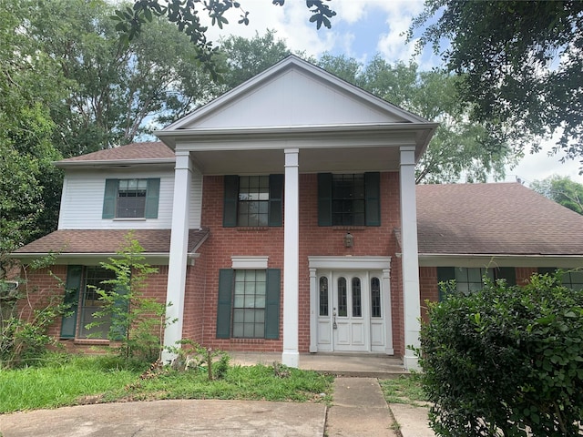 3027 Country Club Blvd, Sugar Land, TX 77478 - greek revival inspired property featuring roof with shingles, brick siding, and covered porch