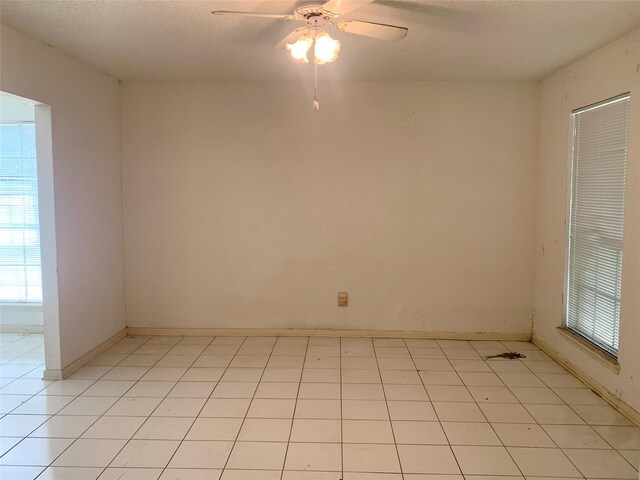 3027 Country Club Blvd, Sugar Land, TX 77478 - spare room with healthy amount of natural light, a ceiling fan, and a textured ceiling