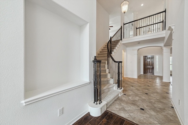 26314 Planters Heath, Katy, TX 77494 - foyer entrance featuring arched walkways, ceiling fan, stairs, a towering ceiling, and ornate columns