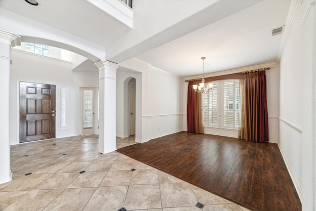 26314 Planters Heath, Katy, TX 77494 - tiled entrance foyer with arched walkways, decorative columns, a chandelier, and ornamental molding