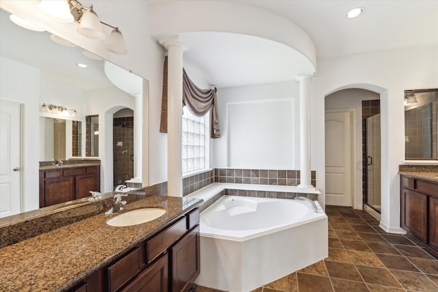 26314 Planters Heath, Katy, TX 77494 - bathroom featuring a stall shower, decorative columns, a bath, two vanities, and recessed lighting