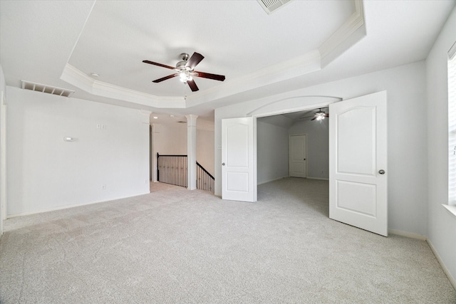 26314 Planters Heath, Katy, TX 77494 - unfurnished room featuring ceiling fan, a raised ceiling, crown molding, light carpet, and decorative columns