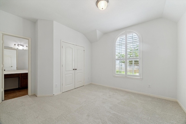 26314 Planters Heath, Katy, TX 77494 - unfurnished bedroom with carpet floors, vaulted ceiling, a closet, and ensuite bath