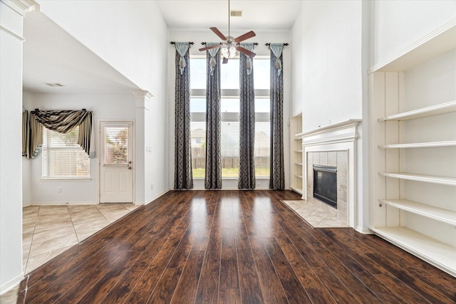 26314 Planters Heath, Katy, TX 77494 - unfurnished living room with ceiling fan, a fireplace, wood-type flooring, and a high ceiling
