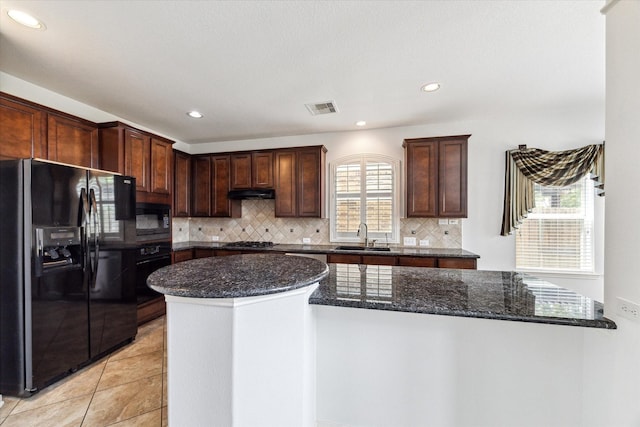 26314 Planters Heath, Katy, TX 77494 - kitchen featuring black appliances, dark stone counters, tasteful backsplash, recessed lighting, and under cabinet range hood